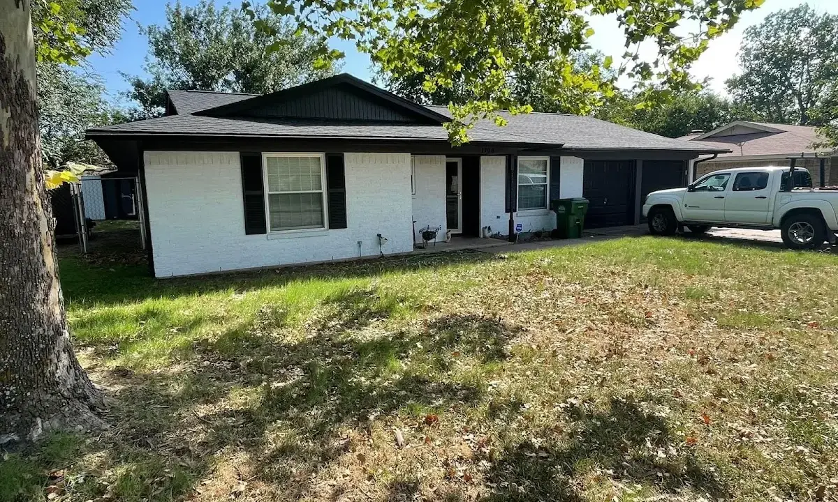 Professional roofing crew working on a residential roof in Orchard Homes